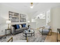 Bright living room with gray sofa and glass coffee table at 4254 River Green Nw Dr # 616, Atlanta, GA 30327