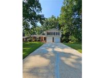 Two-story house with attached garage and a well-manicured lawn at 4670 Eberline Ct, Stone Mountain, GA 30083