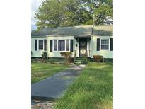 Light green house with black shutters and a small front yard at 939 Beecher Sw Ct, Atlanta, GA 30311