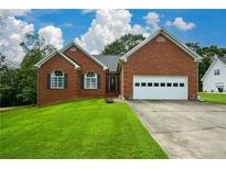Brick ranch home with attached garage and spacious lawn at 37 Red Fox Trl, Euharlee, GA 30145