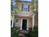 Two-story townhome with light yellow siding and brick accents at 585 Mcwilliams Se Rd # 2307, Atlanta, GA 30315