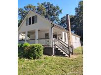 White house with front porch, grey steps, and landscaping at 2203 Hillcrest Ave, Decatur, GA 30032