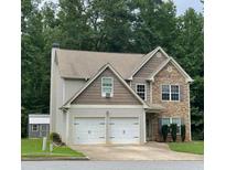 Two-story house with two-car garage and stone accents, offering curb appeal at 110 Iverson Pl, Temple, GA 30179