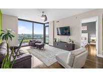 Modern living room with hardwood floors and city view at 270 17Th Nw St # 2304, Atlanta, GA 30363