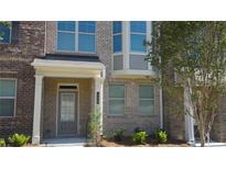 Townhouse exterior with landscaping at 559 Fundao Ln # 21, Lawrenceville, GA 30046