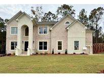 Two-story brick house with a grand entrance and landscaped lawn at 179 Basie Ct, Fairburn, GA 30213