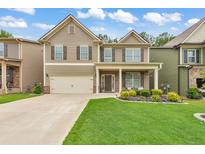 Two story house exterior with a two car garage and nicely landscaped lawn at 437 Livingston Pt, Acworth, GA 30102