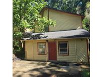 Ranch style home with a red door and mature trees at 2900 Kevin Ln, Jonesboro, GA 30236