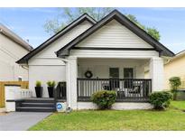 Charming white bungalow with black accents and porch at 976 Washington St, Atlanta, GA 30315