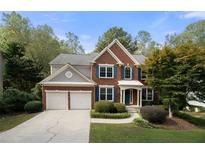 Two-story brick home with a two-car garage at 5540 Oxborough Way, Alpharetta, GA 30005