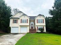 Two-story house with two-car garage and landscaping at 3393 Madison Farm Way, Snellville, GA 30039