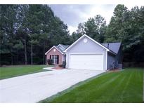 Two-toned house exterior with a driveway at 4205 Old House Dr, Conley, GA 30288