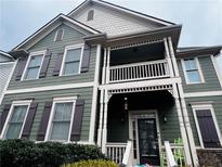 Two-story green house with white accents and shutters at , Atlanta, GA 30318