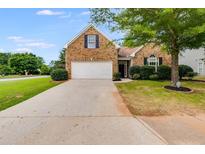 Brick home with a two-car garage and landscaped yard at 5501 Somer Ridge Ct, Douglasville, GA 30134