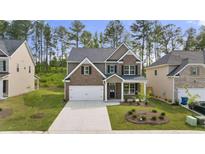 Brick home with a two-car garage and well-maintained lawn at 1698 Lacebark Elm Way, Lawrenceville, GA 30045