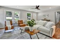 Bright living room with hardwood floors, stylish furniture, and large windows at 163 Glenrose Sw Cir, Atlanta, GA 30354