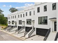 Row of new townhouses with white brick and black accents at 3667 Peachtree Ne Rd # 8, Atlanta, GA 30319