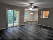 Living room with sliding glass doors to balcony at 2396 Lawrenceville Hwy # F, Decatur, GA 30033