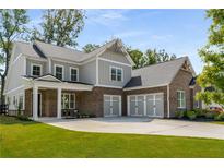 Two story house with brick and siding, three car garage, and manicured lawn at 4960 Iris St, Cumming, GA 30040