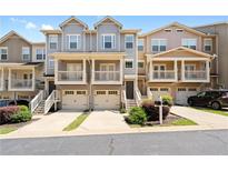 Three-story townhouses with attached garages and front porches at 3023 Liberty Nw Way, Atlanta, GA 30318