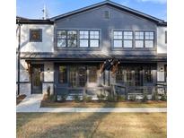 Modern two-story townhome with gray siding and metal roof at 947 Willingham Dr # 2, Hapeville, GA 30354