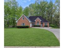Brick house with a large front yard and driveway at 140 Wisteria Blvd, Covington, GA 30016