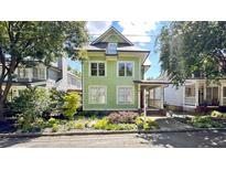 Charming two-story green house with landscaped yard at 79 Hammock Pl, Atlanta, GA 30312