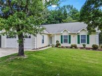 Charming ranch home with two-car garage, green shutters, and manicured lawn at 2556 Kennesaw Springs Nw Ct, Kennesaw, GA 30144