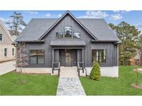 Modern farmhouse exterior with gray siding and stone accents at 100 Cottage Gate Ln, Roswell, GA 30076