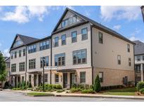 Three-story beige townhouse with gray accents at 3701 Allegretto Cir, Atlanta, GA 30339