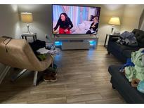 Living room with tile flooring and a large flat-screen TV at 1189 Ashborough Se Dr # J, Marietta, GA 30067