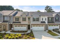 Two-story townhouses with attached garages and landscaping at 348 Elgin Dr # 162, Lawrenceville, GA 30045