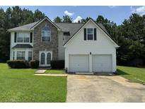 Two-story house with a two-car garage and stone accents at 2112 Bradford Pear Se Cir, Conyers, GA 30013