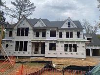 Exterior view of house under construction with gray siding at 180 Thompson Pl, Roswell, GA 30075