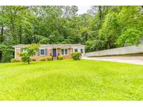 Brick ranch house with a spacious yard and driveway at 6626 Dorian Dr, Union City, GA 30291
