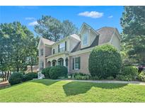 Brick two-story house with manicured lawn and landscaping at 103 Sweetbriar Walk, Stockbridge, GA 30281