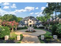 Grand estate home with circular driveway and lush landscaping at 4317 Oglethorpe Nw Loop, Acworth, GA 30101