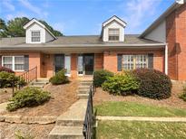 Brick townhouse with a small front yard and landscaping at 3266 Henderson Mill Rd # C, Atlanta, GA 30341