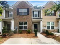 Two-story townhouse with brick and siding exterior at 2469 Piering Dr, Lithonia, GA 30038