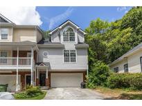 Gray townhome with attached garage and landscaping at 581 Cooper Sw St, Atlanta, GA 30312