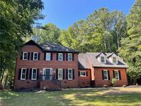 Two-story brick home with black shutters and a large front yard at 320 Royal Ridge Way, Fayetteville, GA 30215