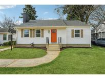 Newly renovated home with white siding and orange door at 1875 Langston Sw Ave, Atlanta, GA 30310