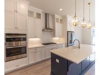 Modern kitchen with white cabinets and large island at 2823 Evanshire Ave, Duluth, GA 30096