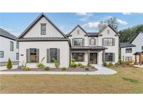 Two story white brick home with gray roof and shutters at 2899 Treeside Terrace, Marietta, GA 30066