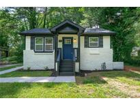 Charming white brick ranch home with a blue door at 2581 Hood Nw Ave, Atlanta, GA 30318