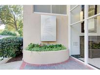 Building entrance with landscaped planter and signage at 2479 Peachtree Ne Rd # 304, Atlanta, GA 30305
