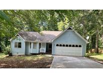 Cute light blue house with a two-car garage at 1325 Smokerise Ln, Auburn, GA 30011