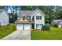 Two-story house with a double garage and a well-maintained lawn at 388 Oakhaven Way, Villa Rica, GA 30180