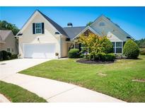 One-story house with a two-car garage and landscaped yard at 1001 S Creek Dr, Villa Rica, GA 30180