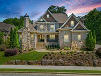 Stunning brick home with stone accents, beautifully landscaped yard, and a large driveway at 850 Camden Park Ct, Atlanta, GA 30342